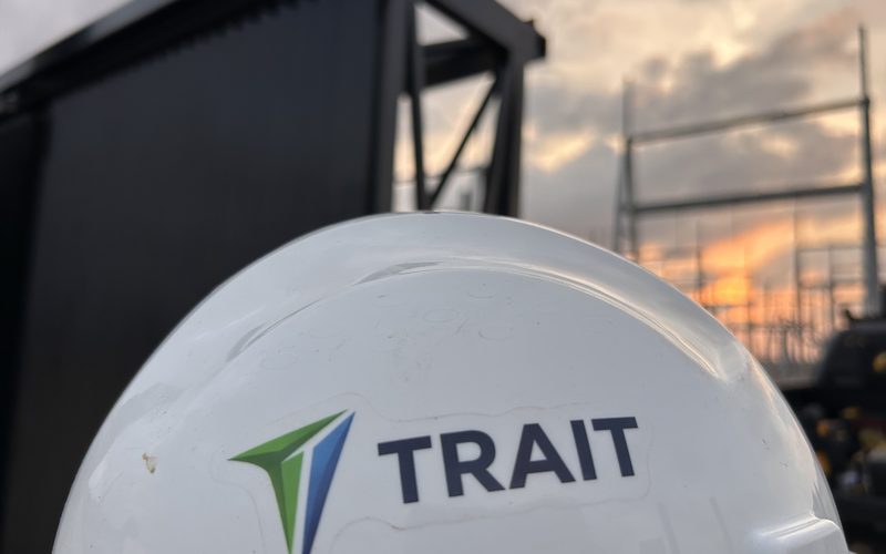 Trait hard hat at an industrial jobsite at sunset