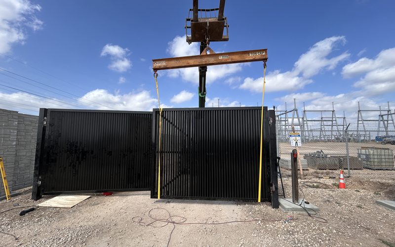 Crane setting a crash-rated substation security gate